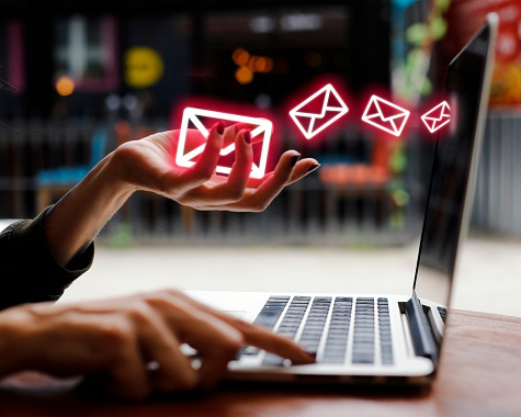 Sending an email on a laptop.